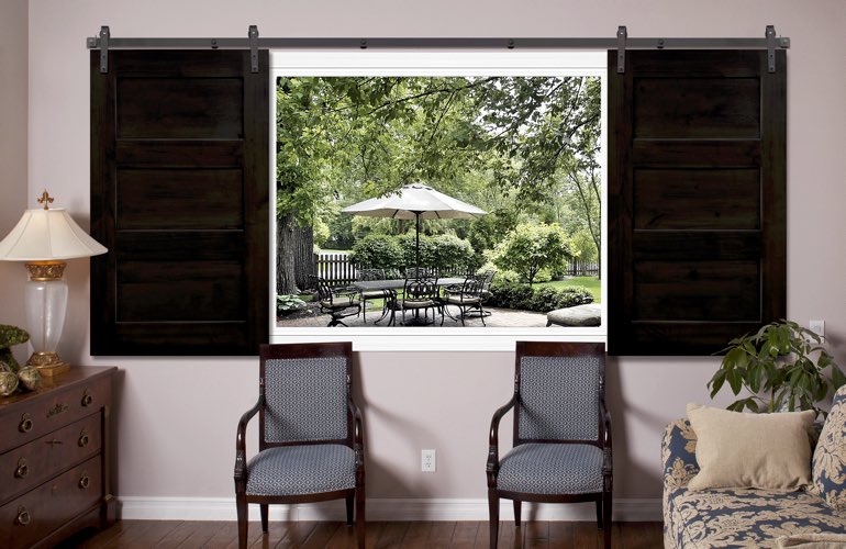 Dark brown sliding barn door shutters in living room